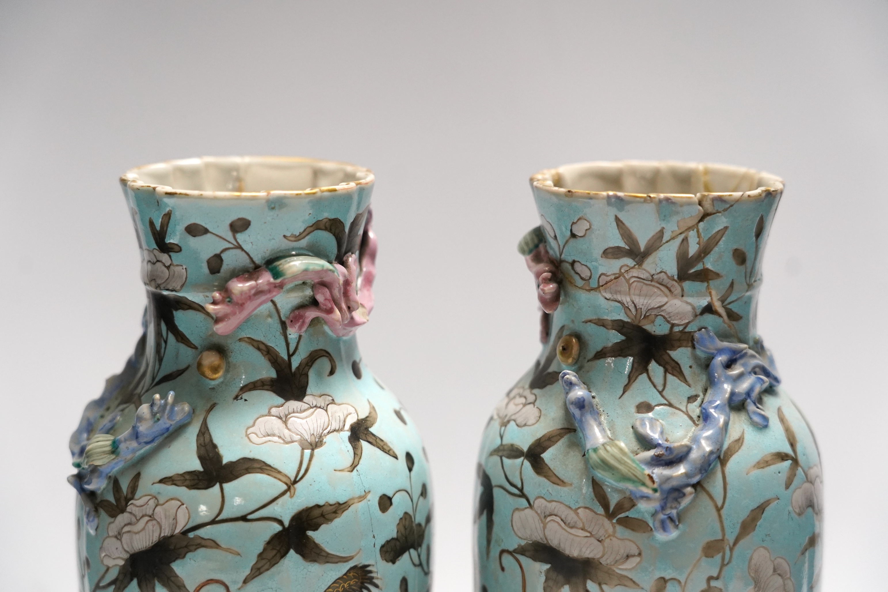 A pair of late 19th century Chinese blue glazed ‘dragon’ vases, 26cm high